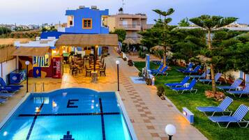 Seasonal outdoor pool, open 9:30 AM to 8:00 PM, pool umbrellas