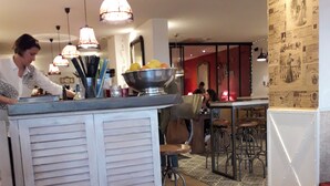 A modern restaurant interior with a central island, pendant lighting, and a patterned wall. - Long House Retreat, Sleeps 6,St Jean de Mont.
 (Saint-Jean-De-Monts)