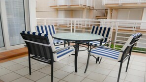 Enjoy a meal or a moment of peace on this outdoor space with a round table and four chairs.