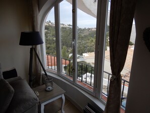 Enjoy a peaceful view of the surrounding neighborhood from the large arched window.