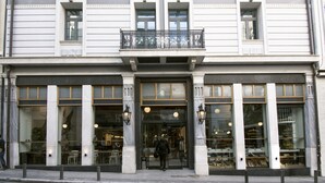 A building with a ground-floor shop and upper-floor residential units. - Ergon House Athens (Athens)