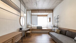 A modern room with a wooden desk, a sofa, and a bed. - Ergon House Athens (Athens)