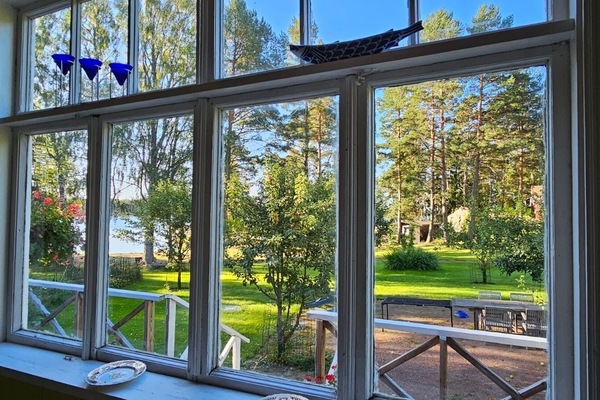 Looking out from cottage verandah window to garden and sea