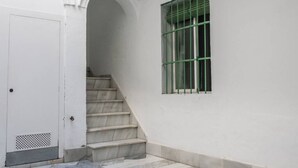 A staircase leading to a door with a barred window.