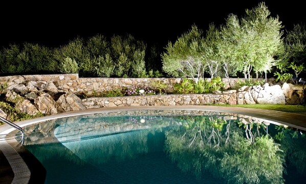 Surrounded by lush greenery, the pool offers a serene escape.