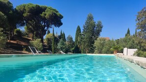 A clear swimming pool with lounge chairs and a stone wall. - Mansion - Port -vendres (Port-Vendres)