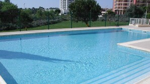 A rectangular swimming pool with blue water and light blue lane markings. - Luxury quiet apartment with private pool near the beach and mountains in Algarve (Portimao)