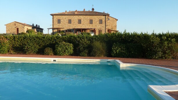 A stone building with a swimming pool in front. - Apartment in Beautifully Restored Medieval Tuscan Village, 7klm from Volterra (Pisa)