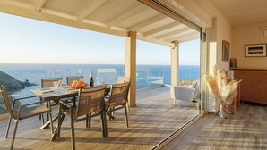 A dining area with a table set for two, overlooking the sea. - Perched on a Hill Overlooking the Cretan Sea (Rethymno)