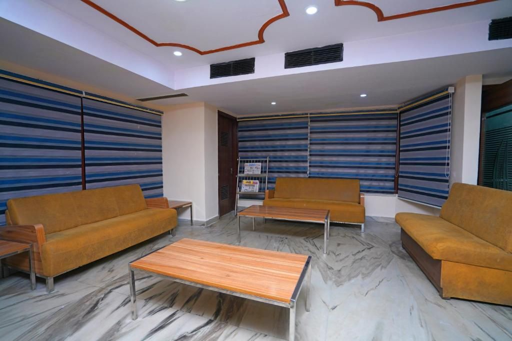 A lobby with striped walls, a sofa, a coffee table, and a bookshelf.