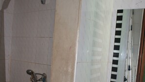 A bathroom with a shower, a sink, and a mirror.