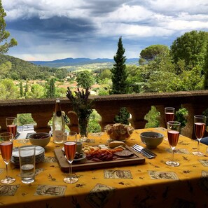 A table set for a meal with a view of a mountainous landscape.