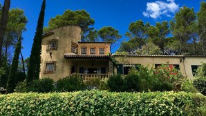A building with a stone facade, multiple windows, and a balcony. - Beautiful House With Tower Close To The Picturesque Town Of Lorgues. (Lorgues)