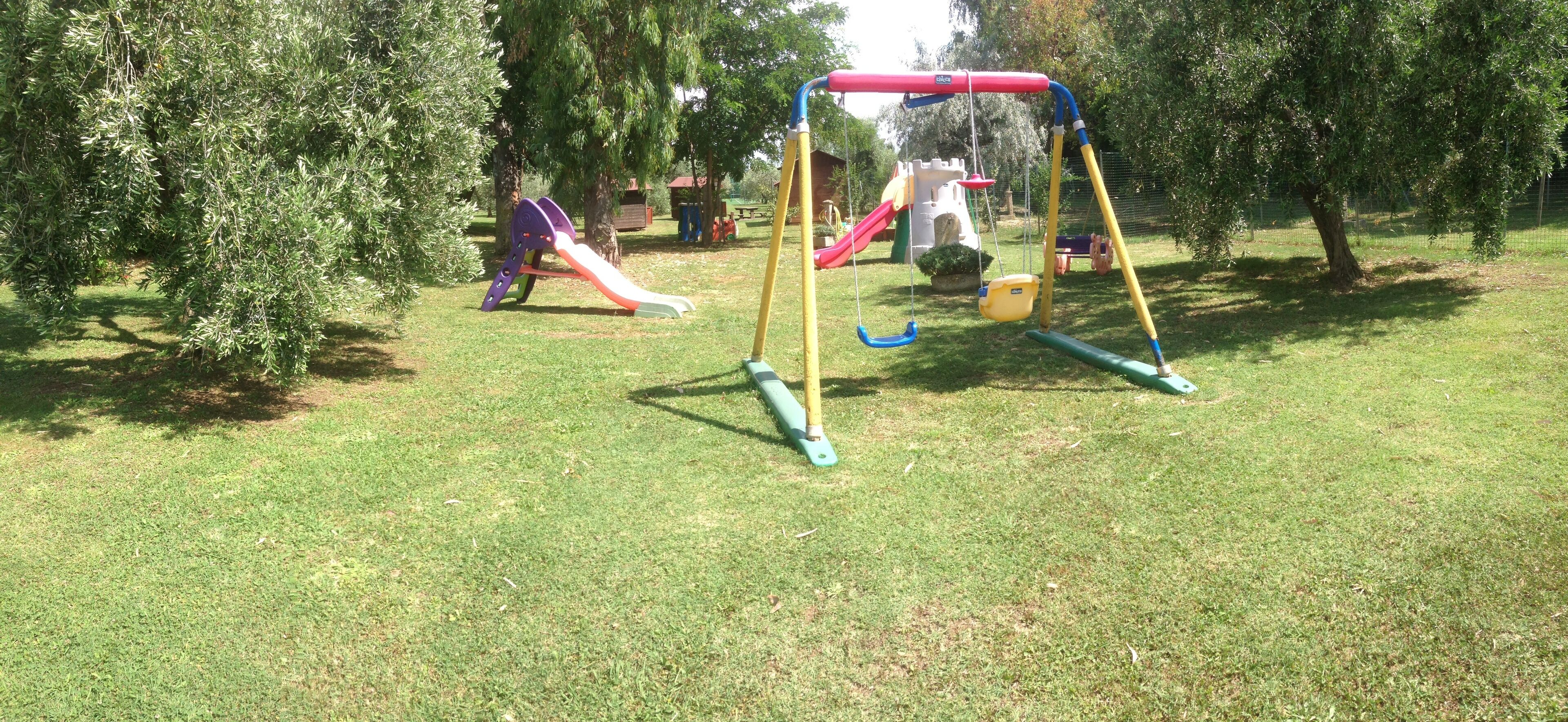 A playground with a swing set and slides.
