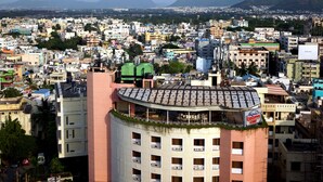 A multi-story hotel with a curved facade, multiple balconies, and a rooftop terrace. - Daspalla Executive Court (Visakhapatnam)