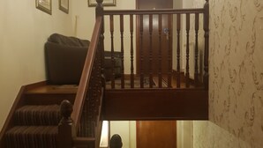 A staircase with wooden balusters leading to a landing. - Castle Inn (Strabane)