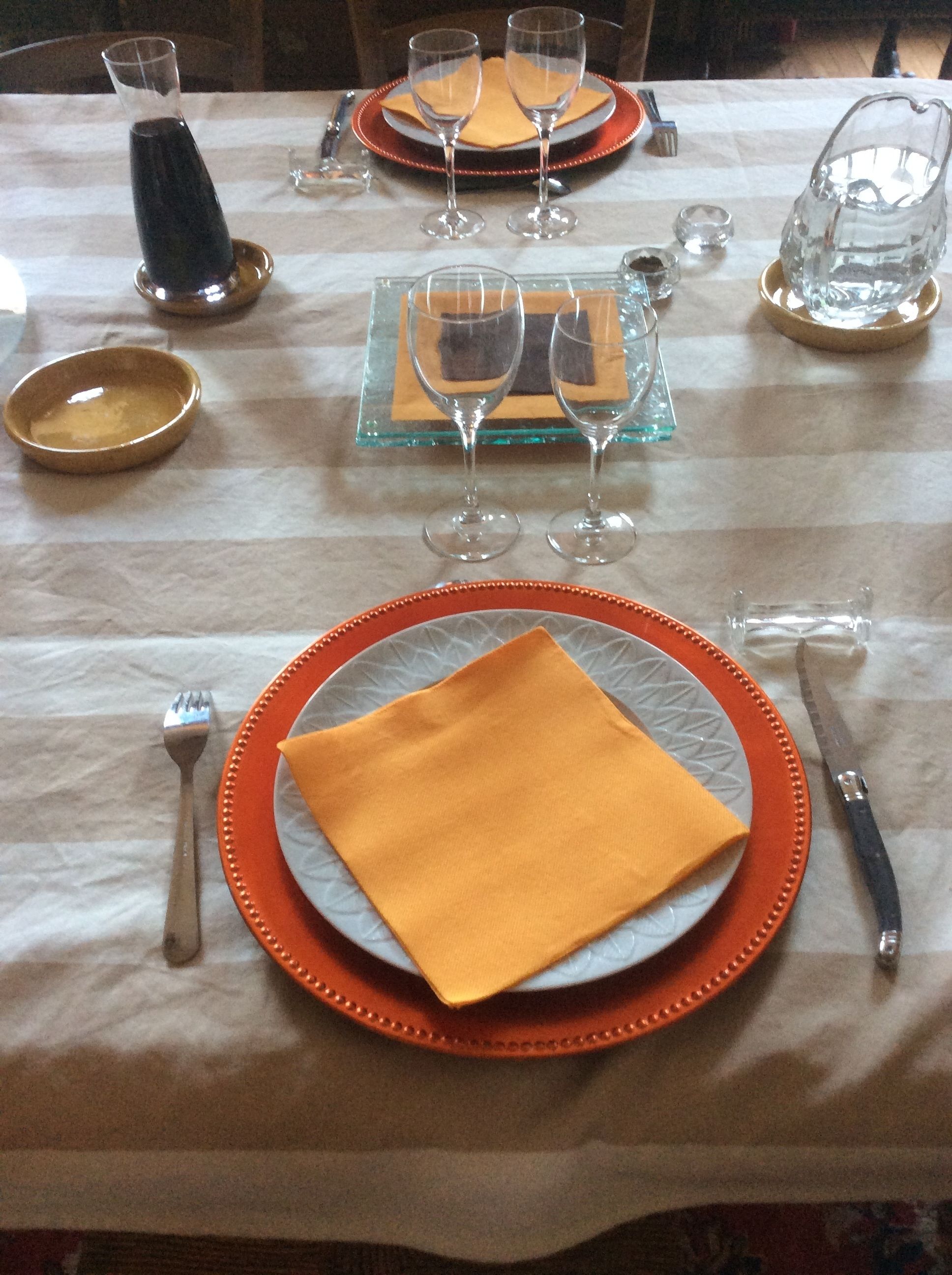 A table set for a meal with plates, glasses, and cutlery.