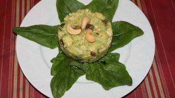 A plate with a food item surrounded by green leaves.