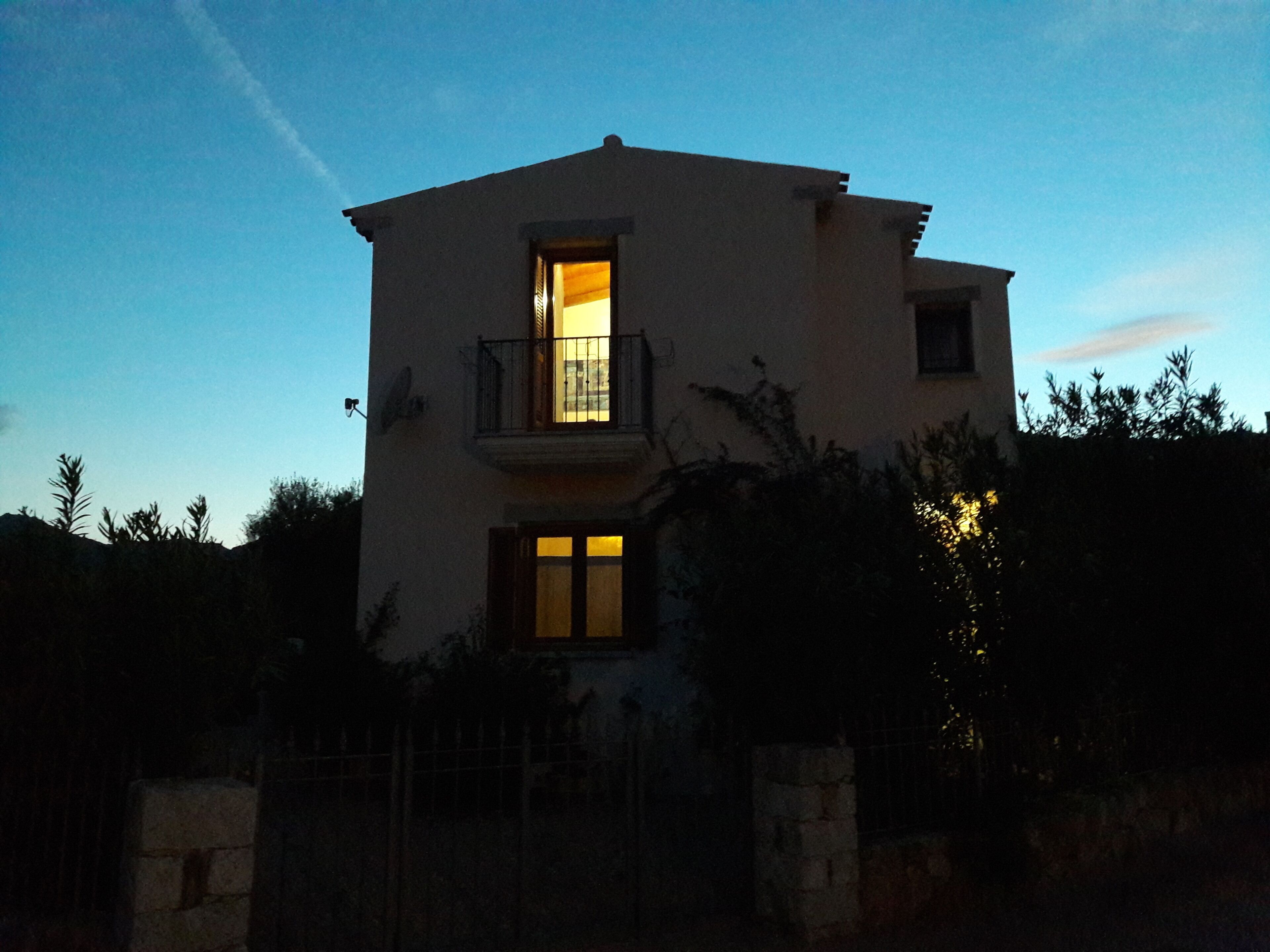 A two-story building with a balcony on the upper floor.