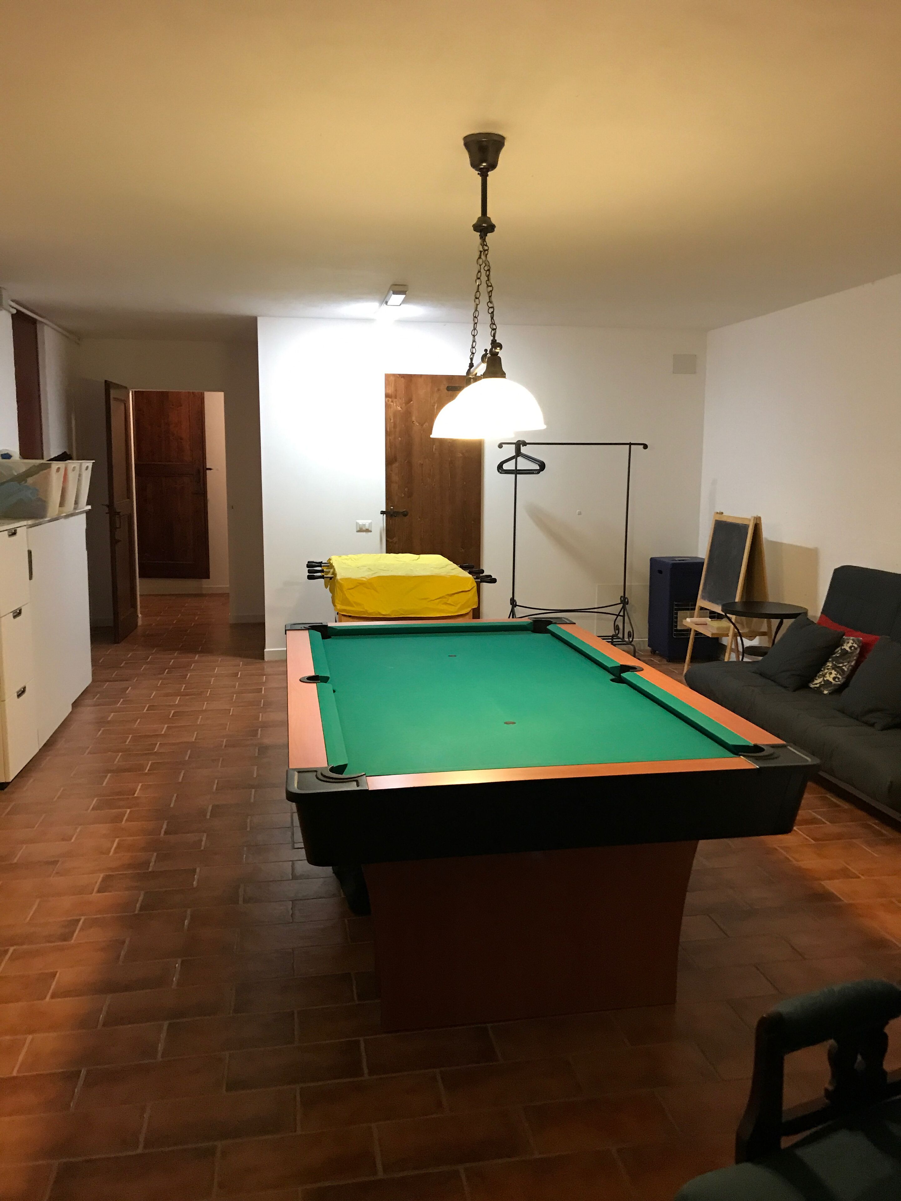 Basement games room with pool table and table football 