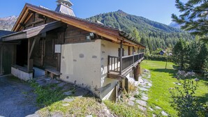 A rustic wooden building with a stone foundation, a wooden porch, and a stone pathway leading to it. - Chalet Du Croz RJ Historic Farmhouse Charm, Sleeps 8, Le Tour (Argentière), France (Le Tour (Argentière))