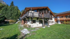 A chalet-style building with a wooden balcony, stone foundation, and a clear sky. - Chalet Du Croz RJ Historic Farmhouse Charm, Sleeps 8, Le Tour (Argentière), France (Le Tour (Argentière))