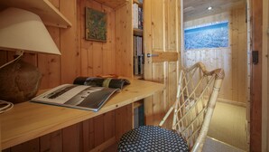 A wooden interior with a desk, books, a lamp, and a chair. - Chalet Du Croz RJ Historic Farmhouse Charm, Sleeps 8, Le Tour (Argentière), France (Le Tour (Argentière))