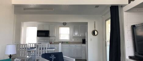 A compact living space with a kitchenette, a dining area, and a TV area.