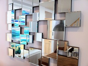 A wall with multiple rectangular mirrors of varying sizes and designs. - Modern Townhouse In Fowey, Cornwall, England (Fowey)