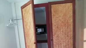 A room with a wardrobe with a wooden finish and a built-in electronic device. - Longan Tree (Saraphi)