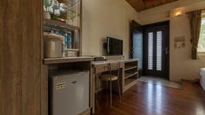 A compact kitchen with a refrigerator, a sink, a microwave, and a small countertop. - Countryside B&B (Ruisui)