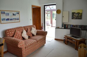 Ferienhaus, 1 Doppelbett, Gartenblick | Wohnzimmer | Flachbildfernseher