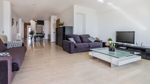 A modern living room with a sofa, a glass coffee table, and a flat-screen TV. - Apartment Colorado 3B By SunVillas Mallorca (Port de Pollensa)