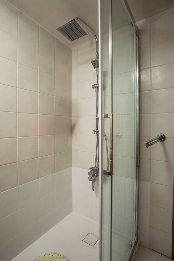 A glass-enclosed shower with a handheld showerhead, a wall-mounted faucet, and a control panel. - 2 room apartment ARES for 2-4 pers. in villa Mylos - great sea views in Ialysos (Rhodes)