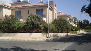 Una calle residencial con casas de techos de tejas y antenas parabólicas.