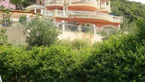 A multi-story building with balconies, surrounded by greenery. - Special Offer for August  (Corfu)