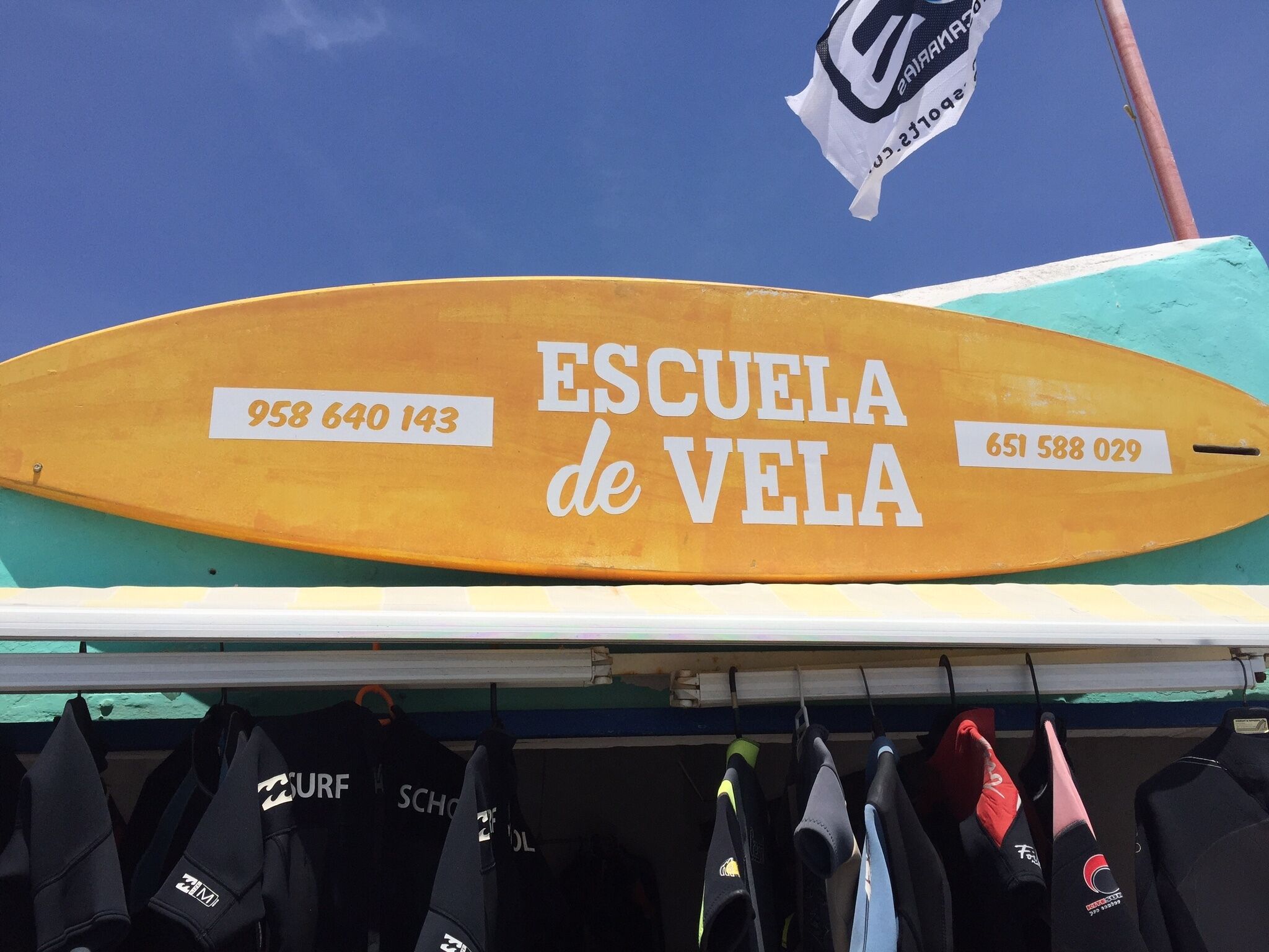 Watersports on beach include sailing, paddleboards, windsurfing, kayaks, pedalos
