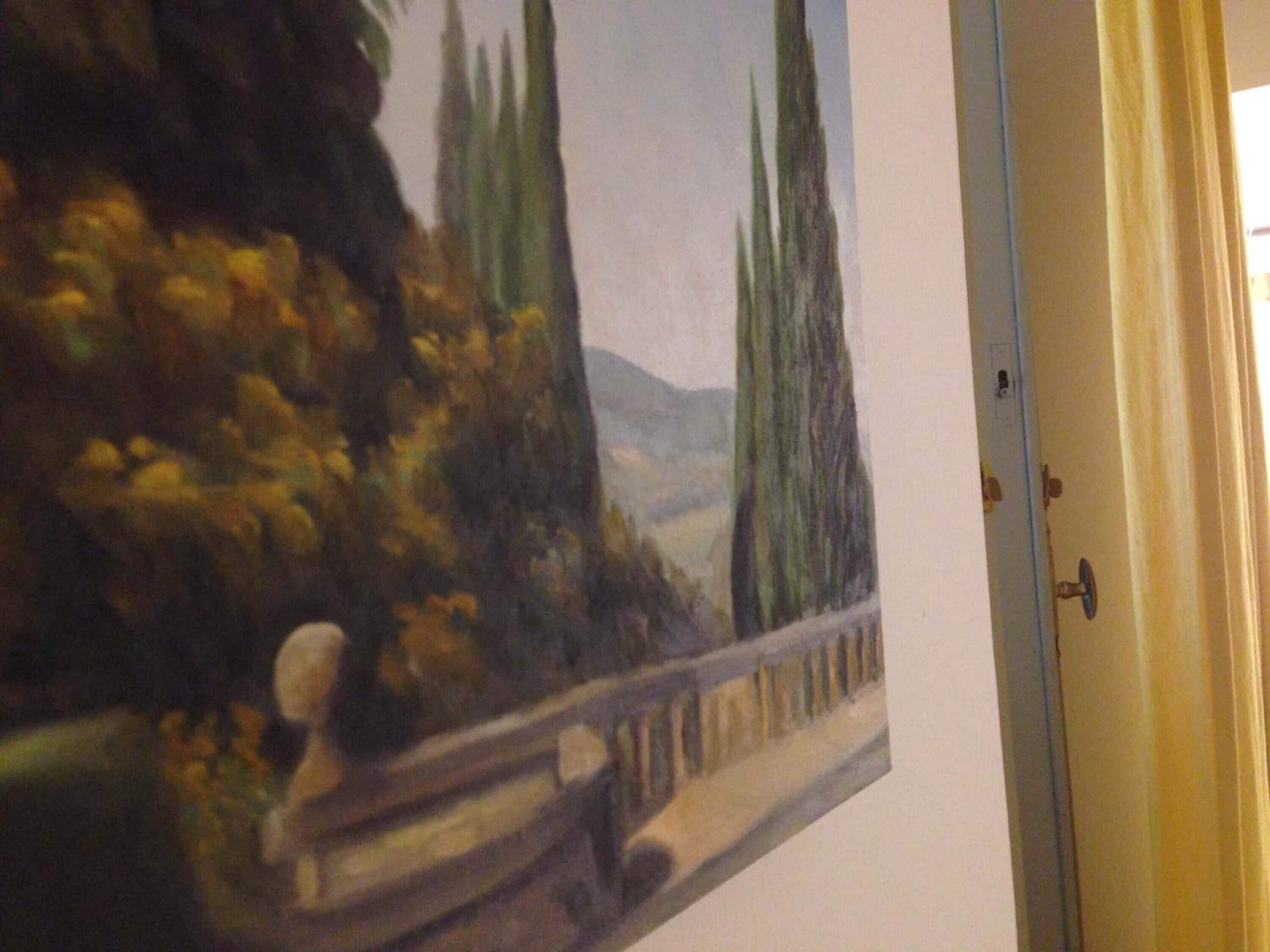 A painting of a landscape with trees and a bridge.