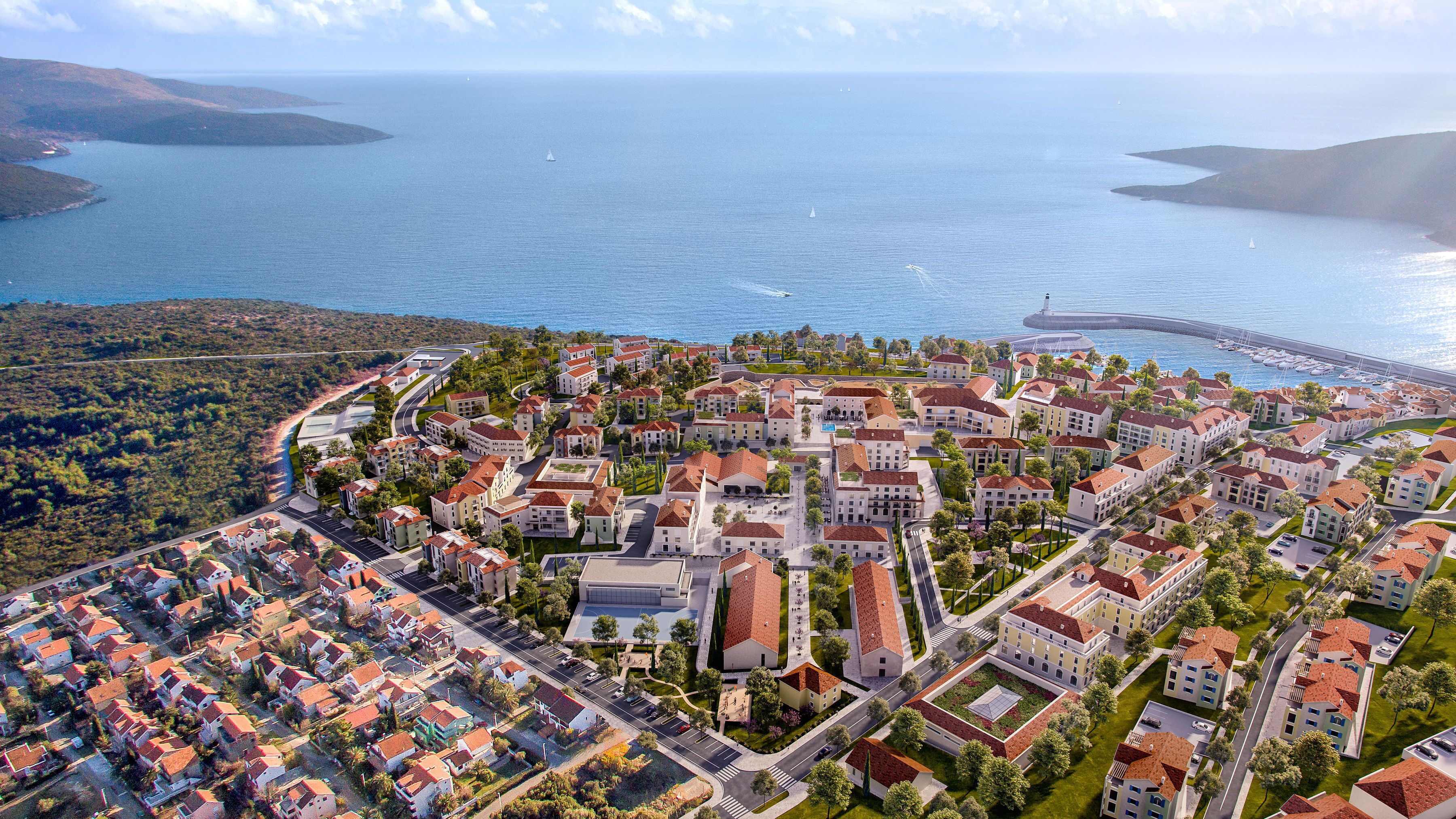 Ilmakuva rannikkokaupungista, jossa näkyy venesatama, asuinrakennuksia ja huomiota herättävä majakka.