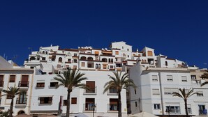 A multi-story building with balconies and a clear blue sky. - Villa Ra - Enchanting Moraira Villa with Secluded Pool and Sea View      (Alicante)