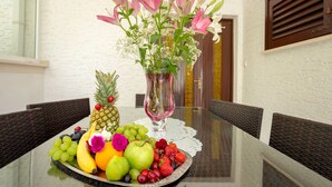 A table with a fruit platter, a vase with flowers, and wicker chairs. - Vacation that you'll remember for a long time :) (Korcula)