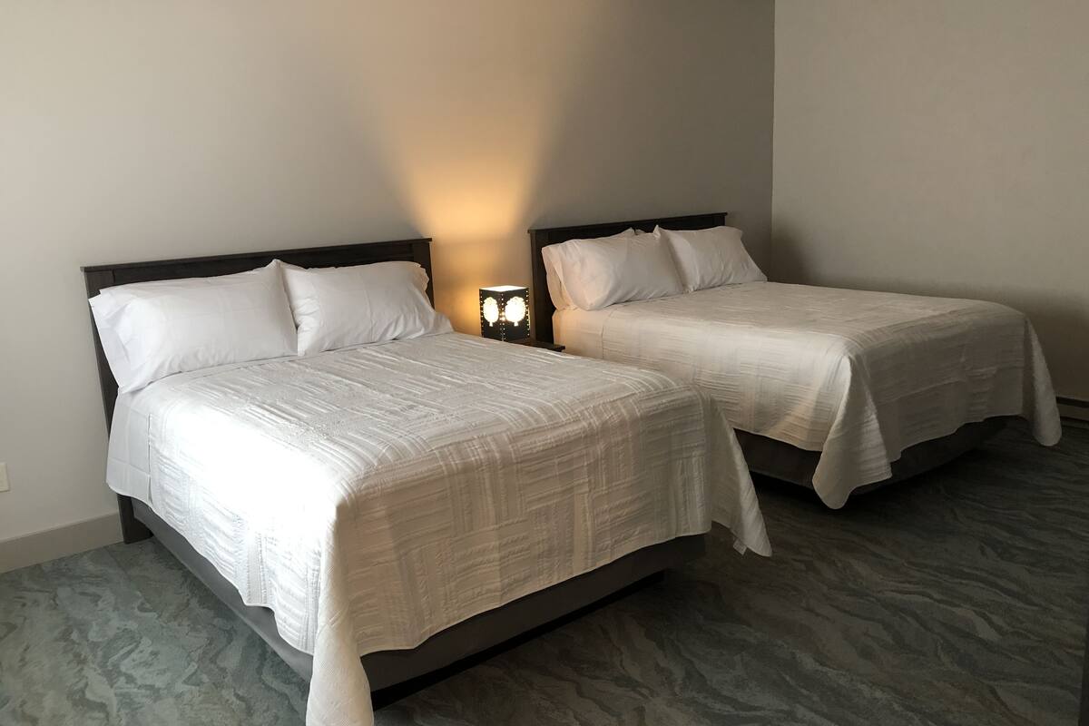 deluxe quadruple room, 2 queen beds, non smoking | in-room safe, blackout curtains, iron/ironing board, free wifi