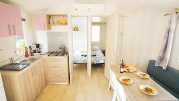 Premium Mobile Home | Private kitchen | Full-size fridge, stovetop, cookware/dishes/utensils, dining tables