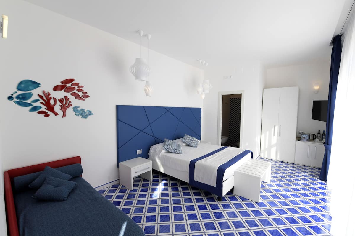A modern bedroom with a bed, bedside tables, a wardrobe, and a bathroom.