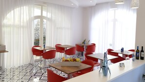 A modern dining area with red chairs, white tables, and a fruit bowl on the table. - Palazzo San Giovanni (Scala)