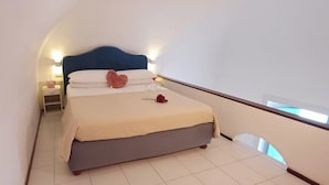 A bedroom with a bed, bedside table, lamp, and a view of the outside. - HOUSE WITH TERRACE AND SEA VIEW (Positano)