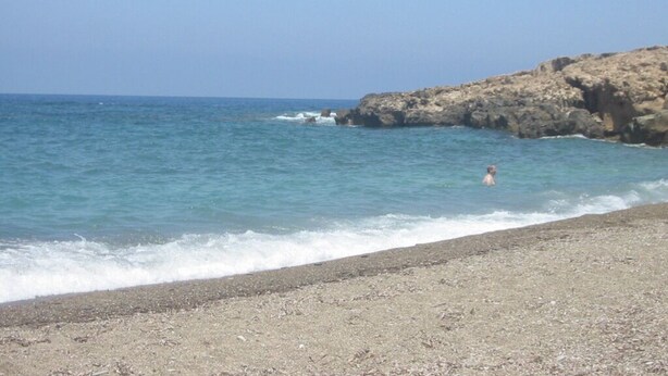 A beach with rocky cliffs and calm sea. - Detached Villa In Cul-de-Sac With Private Pool And Sea Views & Free WiFi. (Peyia. Paphos)