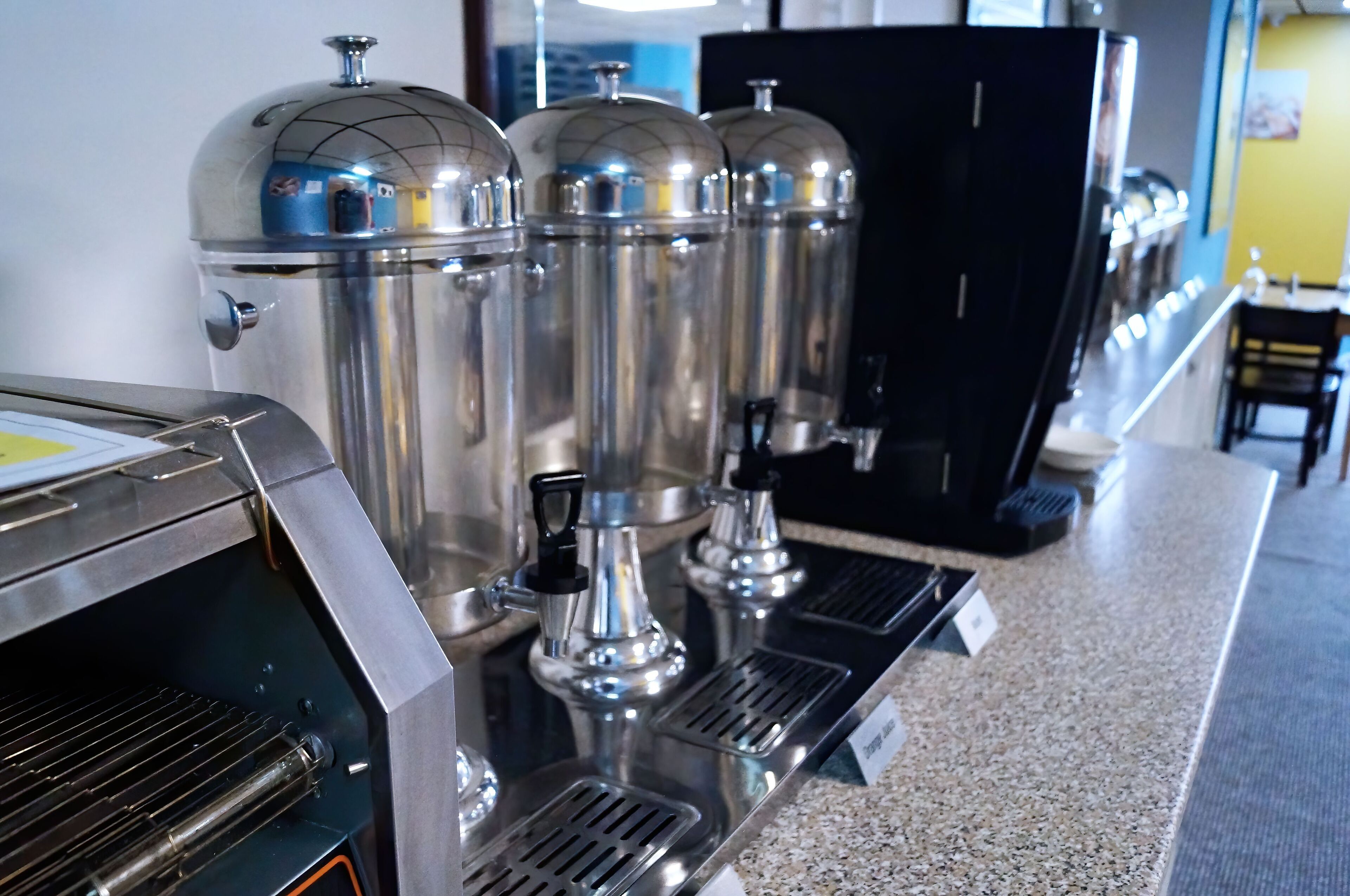 A coffee machine with multiple dispensers and a steam wand.
