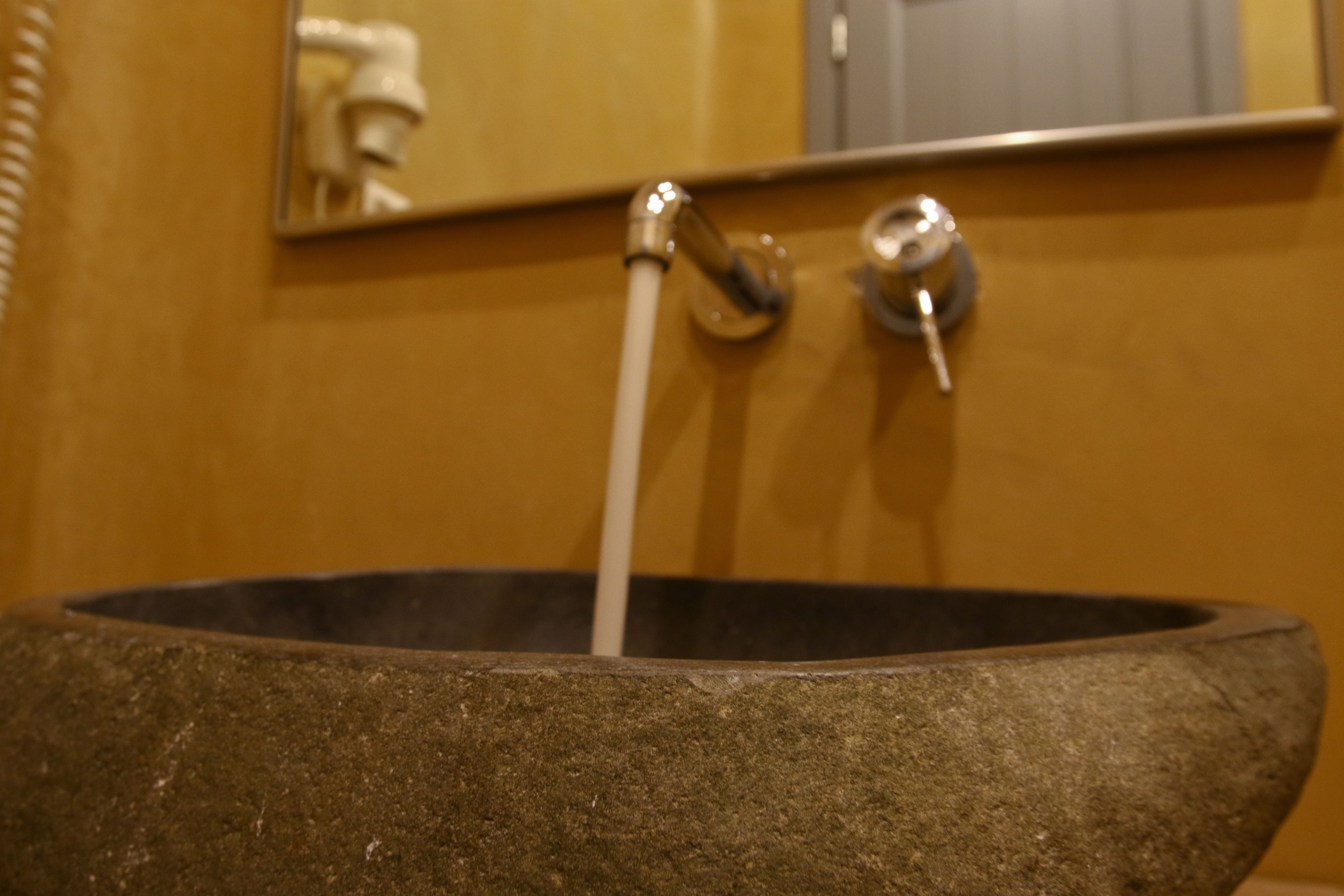A stone basin with a faucet.