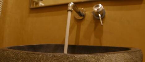 A stone basin with a faucet.